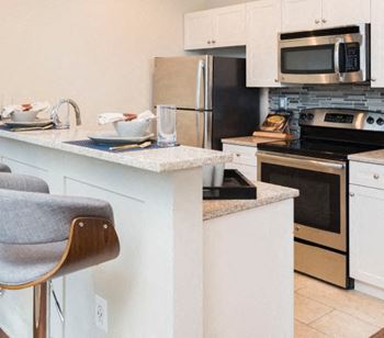 A modern kitchen at 1900 Arch with with sleek granite countertops